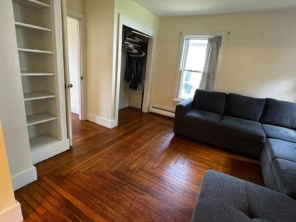 Living room after Move In Out Cleaning Service with polished wood floors and organized layout.