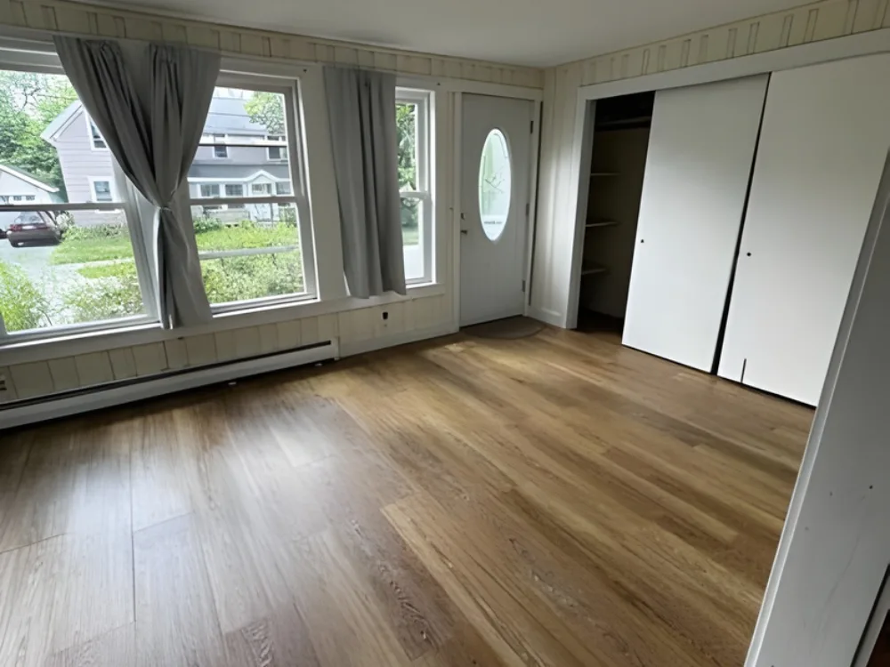 Residential cleaning completed in living room with cleaned floors and windows