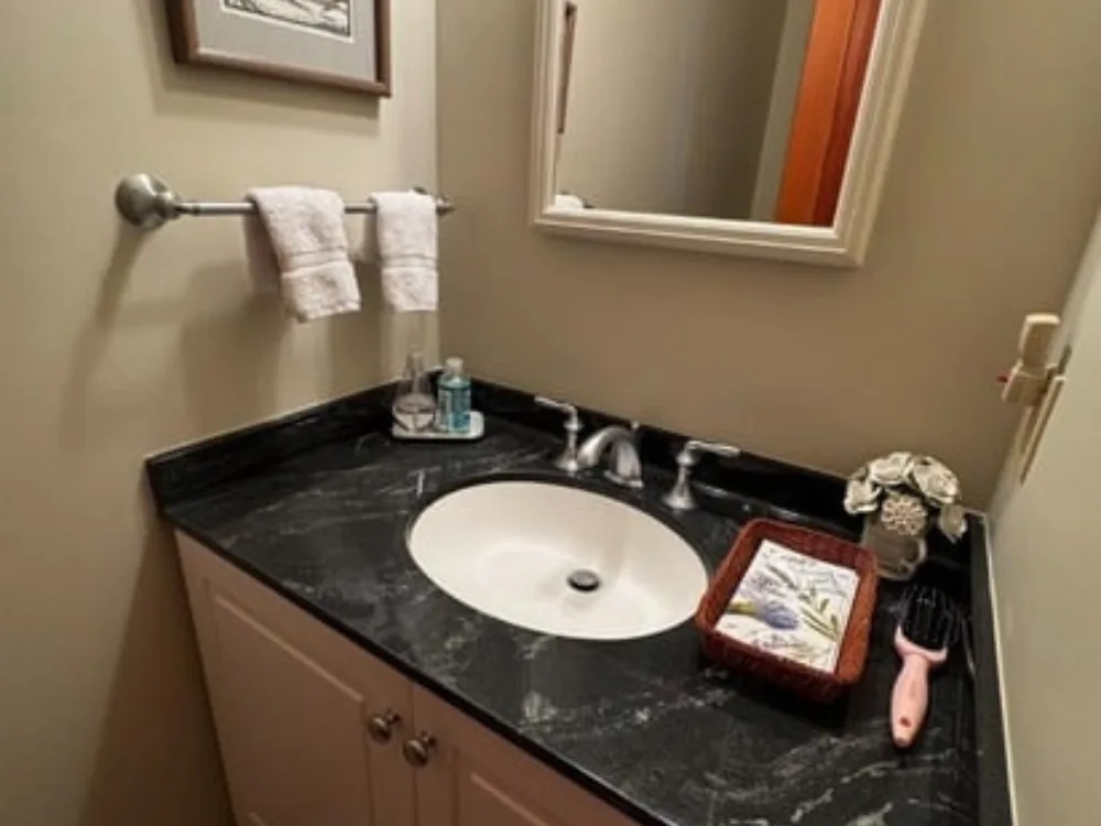 Bathroom cleaning focused on sink, countertop, and organized vanity area