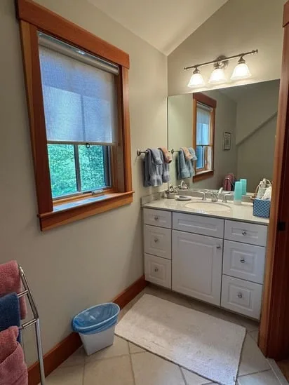 A wide-angle view of a bright bathroom showcasing the results of a professional bathroom deep cleaning.