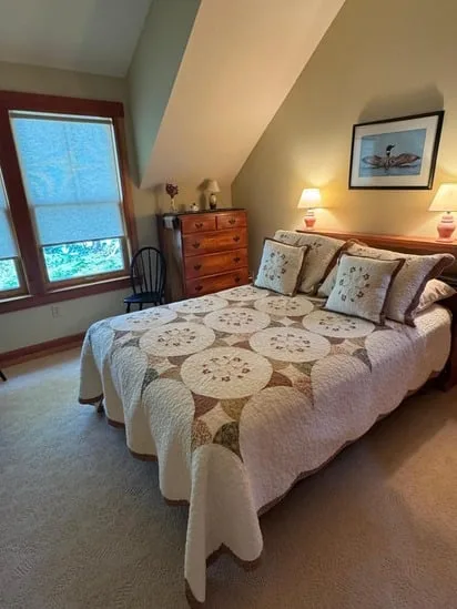 Dusted lamps and a freshly made bed highlighting the quality of this residential bedroom cleaning.