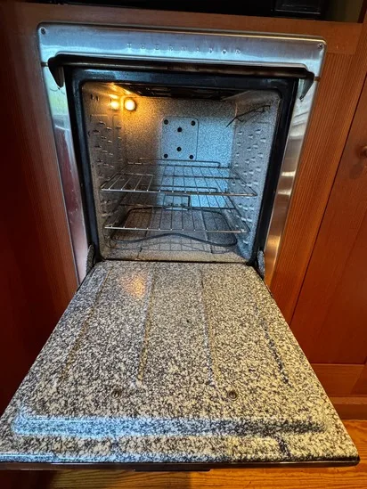 The spotless interior of a built-in appliance after our recent deep oven cleaning completely removed all existing grease.